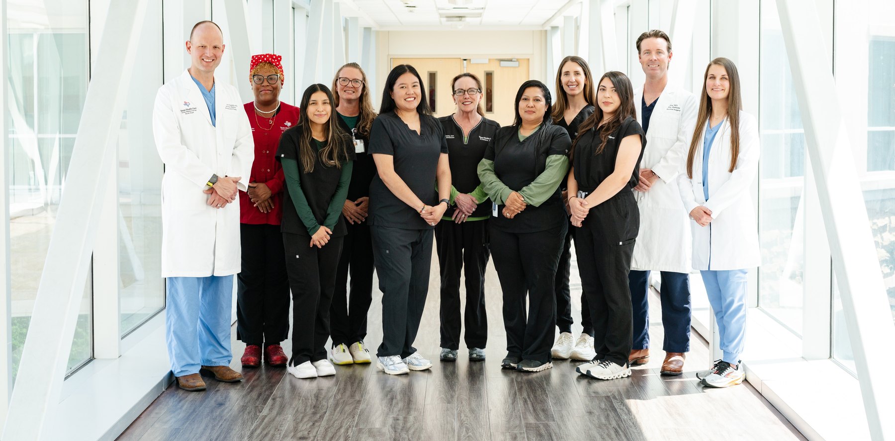 The Fort Worth Urogynecology team &mdash; physicians, nurse practitioners and clinical staff &mdash; standing together in a sunlit hallway.